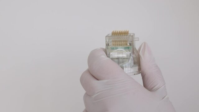 A maniple, a nozzle for a cosmological procedure. Needle rf-lifting. Room, white background. Cosmetology and medical services office. Microneedle radio frequency lifting device. Hardware cosmetology. 