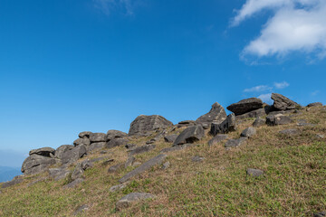 Fototapeta na wymiar Stones on the plateau meadow under the blue sky
