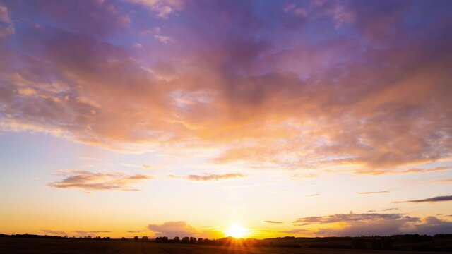 Clouds fly across the sky at sunset. Timelapse