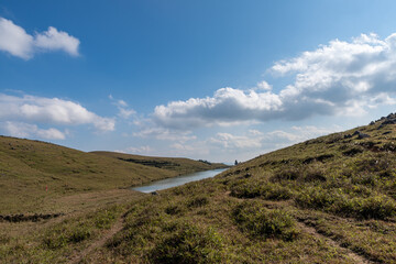 Blue sky and white clouds, withered and yellow meadow