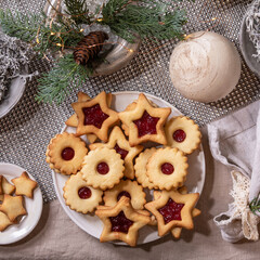 Christmas Linz shortbread biscuits cookies with wooden decorations on xmas table. Flat lay