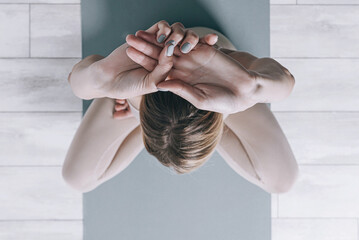woman over forty performs yoga asanas
