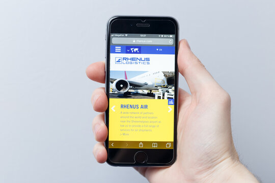 Moscow / Russia - 04.21.2019: A hand holding a smartphone which displays Rhenus & Co logo on the official website homepage. Rhenus & Co logo visible on smartphone screen. Illustrative editorial