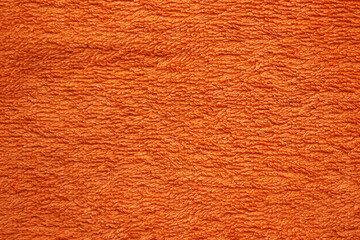Textil-Hintergrund von einem orangen Frottee-Handtuch