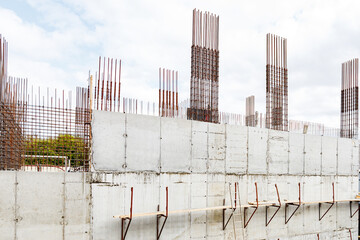 Steel bars reinforcement on construction site, vertical wall. Formwork used for concrete layering.