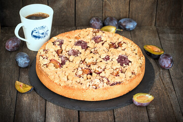 Crumble tart with plum, homemade plum pie and coffee
