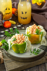 Halloween funny idea for party food, decoration celebration kid party meal. Halloween dinner with Paprika stuffed with spaghetti and chicken tomato bolognese sauce.