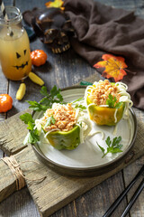 Halloween funny idea for party food, decoration celebration kid party meal. Halloween dinner with Paprika stuffed with spaghetti and chicken tomato bolognese sauce.