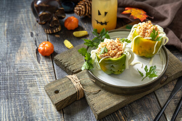 Halloween funny idea for party food, decoration celebration kid party meal. Halloween dinner with Paprika stuffed with spaghetti and chicken tomato bolognese sauce. Copy space.