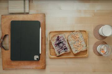 Break time meal sandwich on office wooden desk.