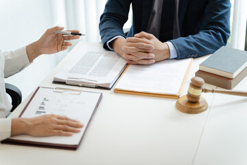 Lawyer Legal counsel presents to the client a signed contract with gavel and legal law. justice and lawyer Business partnership meeting concept.