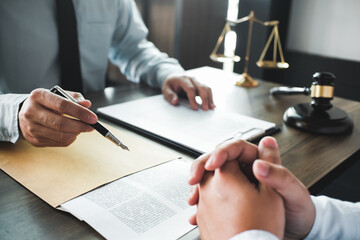 Legal counsel presents to the client a signed contract with gavel and legal law. justice and lawyer concept.