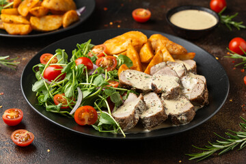 Roast Pork Tenderloin in mustard gravy with vegetables and potato wedges