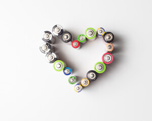 Used batteries are laid out in the shape of a heart. Will be recycled