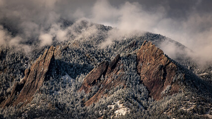 Snow and clouds cover the Flatirons in Boulder, Colorado © KMP