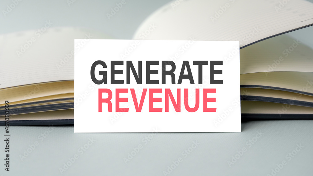 Poster a white business card with generate revenue text stands on a desk against the background of an open 