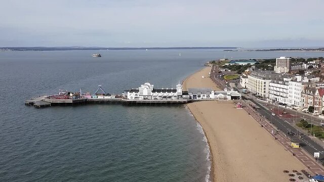 Aerial footage along the Southsea Seafront with the elegant Pier and Victorian buildings at this popular resort in Southern England.