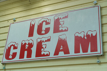 Old fashioned ice cream sign with red lettering