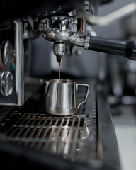 Fototapeta na wymiar coffee machine pours coffee into a metal cup
