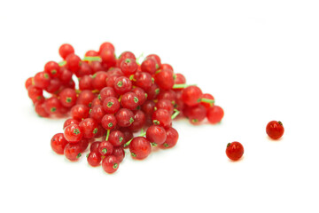 Fresh organic ripe red currant in dew drops in a heap and whole isolated on white background.