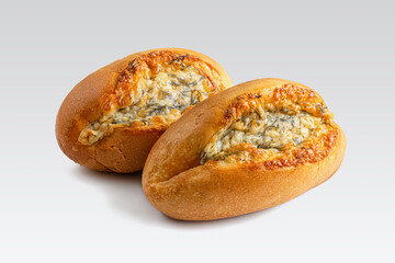Two buns with a golden crust with cheese and herbs