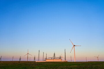 Wind farm against the blue sky early in the morning. Alternative energy concept