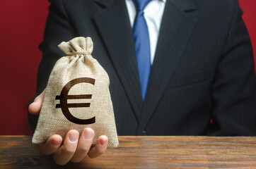 Man gives a euro money bag. Loan issuance. Financial support, leasing. Investments, financing...