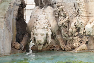 Fototapeta na wymiar Four Rivers Fountain Detail with Sculpted Lion at Piazza Navona in Rome, Italy