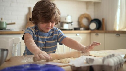 Little kid learns to cook boy rolls and plays with dough