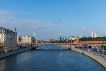 Cityscape of Moscow city downtown district in Russia with Moscow Kremlin, Moskva river and Moskvoretskaya Embankment. Blue sky with few clouds. Travel in Russia theme.