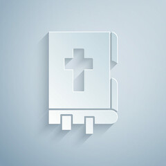 Obraz premium Paper cut Holy bible book icon isolated on grey background. Paper art style. Vector Illustration