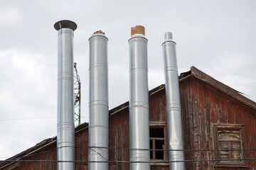 attic of an old wooden house against a gray cloudy sky, close-up