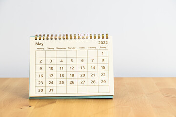 May 2022 calendar on wooden table