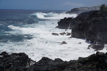 waves crashing on rocky shore on windy day la réunion france