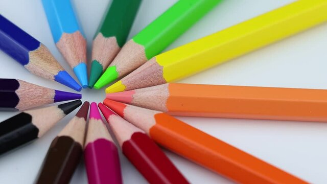 Bright colored pencils rotating around