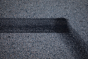 Fototapeta premium asphalt texture with lines, On dark grey asphalt with lines and curves, abstract street background