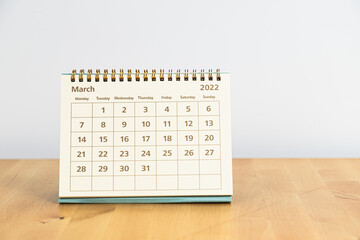 March 2022 calendar on wooden table