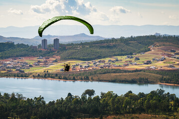 Paraglider over Lagoa dos Ingleses in Brumadinho Minas Gerais and view of housing development