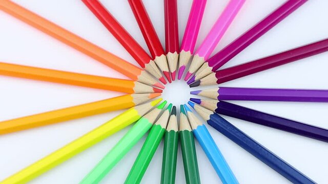 Bright colored pencils rotating around