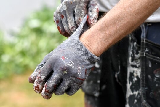 A man putting on protective gloves for painting