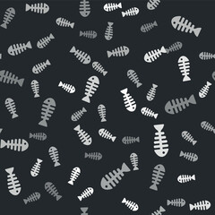 Grey Fish skeleton icon isolated seamless pattern on black background. Fish bone sign. Vector