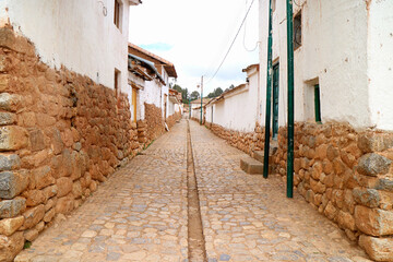 Stone path among the Old Stone Masonry Buildings of Chinchero, the Andean village in Sacred Valley of the Incas, Cuzco, Peru