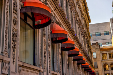Awnings overhanging windows along a neo-classical building in Montreal