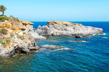 People swim and sunbathe at the sea