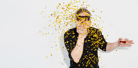 Holiday banner. Party time. Festive celebration. New Year. Happy man in sunglasses with alcohol...