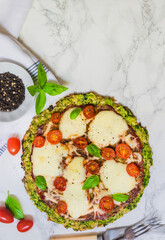 broccoli pizza crust with cherry tomatoes and mozzarella cheese