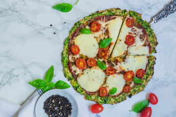broccoli pizza crust with cherry tomatoes and mozzarella cheese