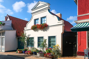 A typical German village house with flowers in front in the historic center of Warnemunde Rostock,...