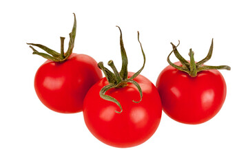 three large red ripe tomatoes on a branch isolated on a white background, close-up