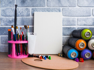 contemporary art, a set of advanced artists with a blank canvas and assorted acrylic paints, markers and sprays